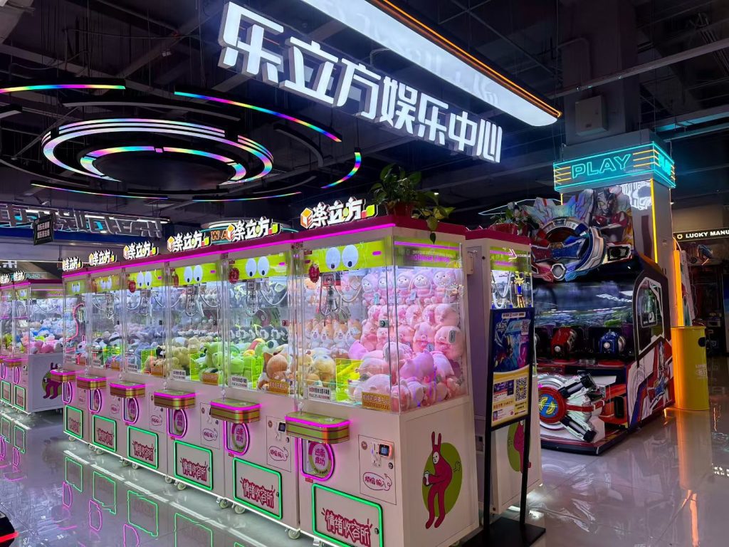 Colorful arcade game zone with claw machines and prize winning games - GO2AMUSE