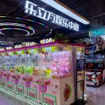 Colorful arcade game zone with claw machines and prize winning games - GO2AMUSE