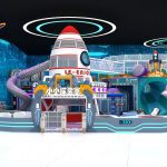 Front view of space themed indoor playground showing rocket ship centerpiece