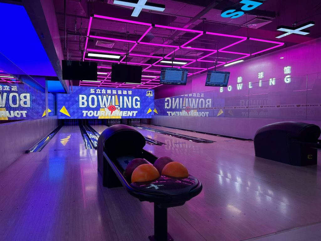 Professional bowling alley with neon lighting and tournament setup - GO2AMUSE